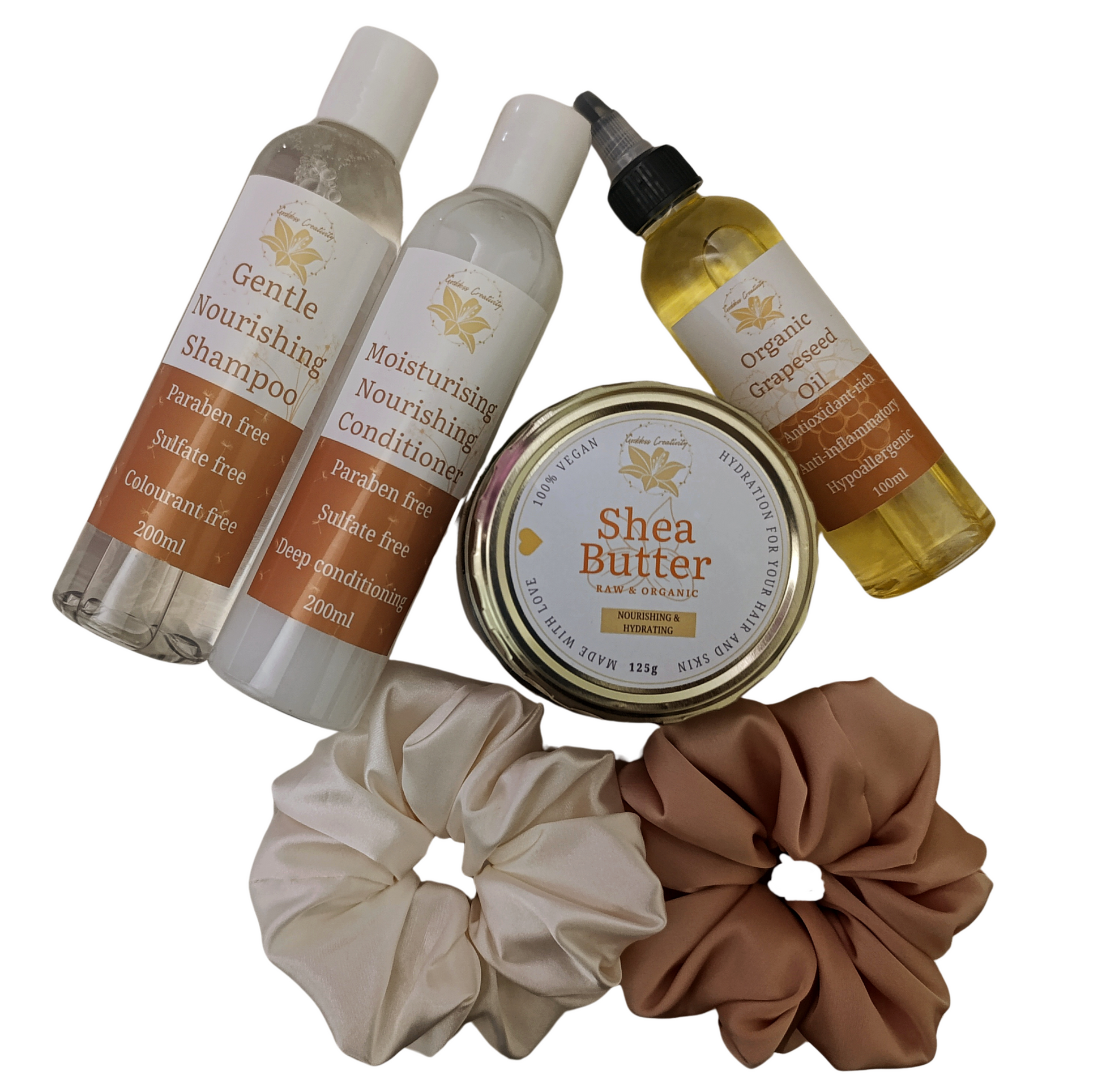 Goddess Creativity Glow and Grow Kit featuring Gentle Nourishing Shampoo, Moisturising Nourishing Conditioner, Organic Grapeseed Oil, Raw & Organic Shea Butter, and two satin scrunchies on a textured cream background